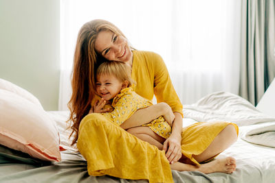 Portrait of young woman sleeping on bed at home