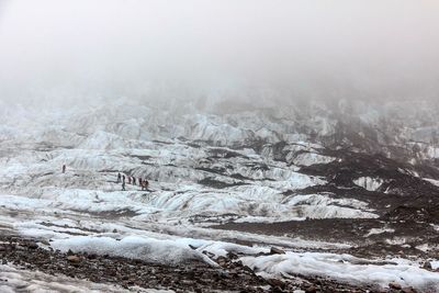 Scenic view of snow covered mountains against sky