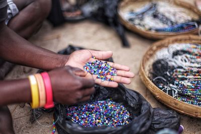 Cropped hands of man holding multi colored beads