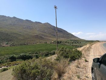 Scenic view of land and mountains against sky