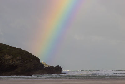 Rainbow over sea against sky