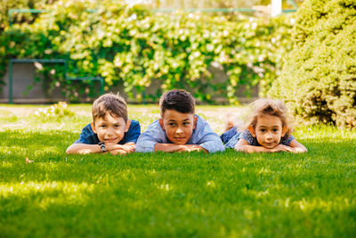 Portrait of smiling boy lying on grass