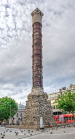 Low angle view of historical building against cloudy sky