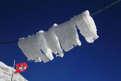 Low angle view of flags against sky