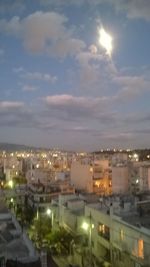 Illuminated cityscape against sky at night