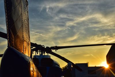 Low angle view of silhouette men against sky during sunset