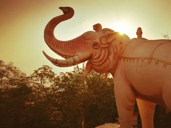 Low angle view of elephant statue against sky