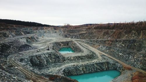 Idyllic shot of ponds at mine against sky