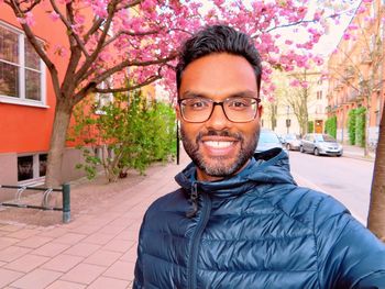 Portrait of man wearing warm clothing standing on sidewalk