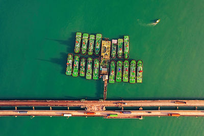 Aerial view, fleet of tug boats moored in a port.