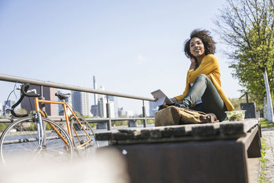 Thoughtful businesswoman sitting on bench