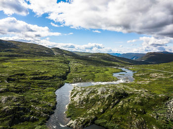Scenic view of river amidst mountains against sky
