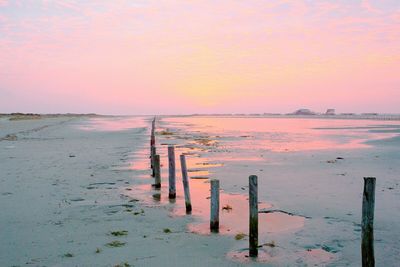 Pier on sea at sunset