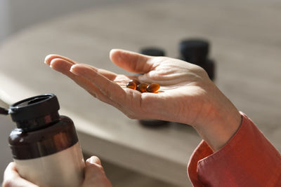 Close-up of woman holding pills