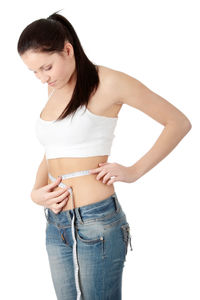 Young woman standing against white background