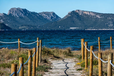 Scenic view of sea and mountains against clear sky