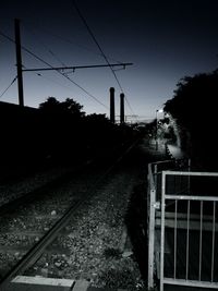 View of railway tracks against clear blue sky