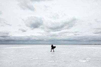 Man in sea against sky