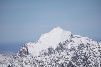 Scenic view of snowcapped mountains against clear blue sky