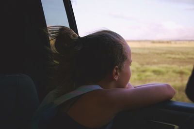 Portrait of boy looking through window