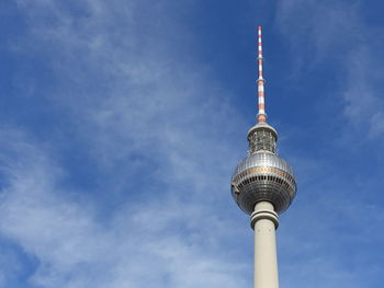 Low angle view of communications tower against sky