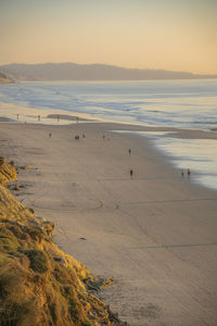 Scenic view of beach against sky during sunset