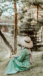 Side view of a woman sitting on field