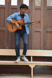 Full length of man playing guitar