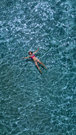 High angle view of man swimming in sea