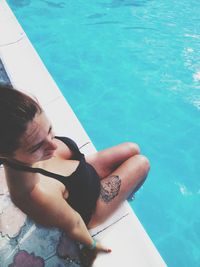 High angle view of hands in swimming pool