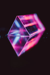 Close-up of illuminated lighting equipment against black background