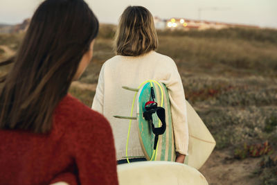 Rear view of couple standing on land