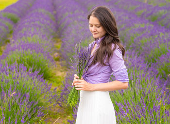 Beautiful young woman standing on land