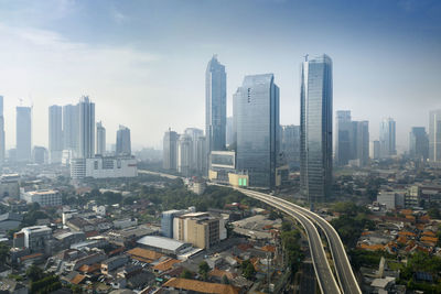 Aerial view of modern buildings in city against sky