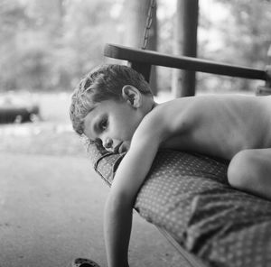 Portrait of cute boy sitting outdoors