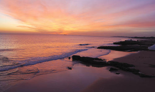 Scenic view of sea against sky at sunset