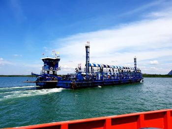 Lifeguard ship in sea against blue sky