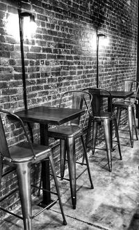 Empty chairs and tables against wall