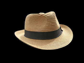 Close-up of hat against black background