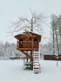 Built structure on snow covered field against sky