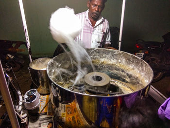 Man preparing food at market stall