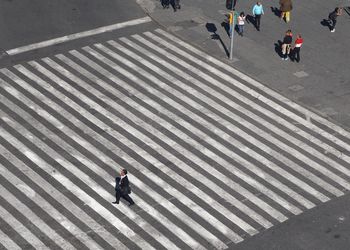 High angle view of people walking on zebra crossing