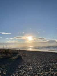Scenic view of beach against sky during sunset