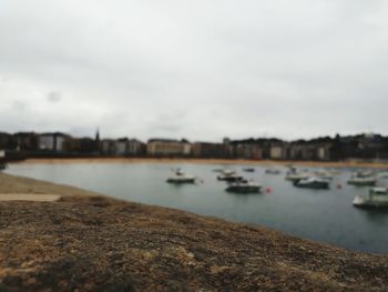 Close-up of retaining wall by river against sky