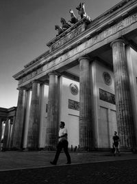 Tourists in front of columns