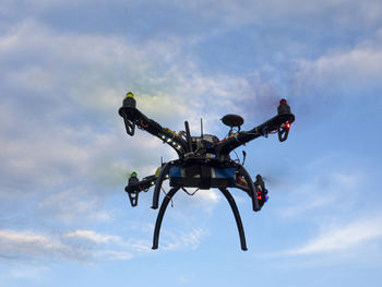 Low angle view of helicopter against sky