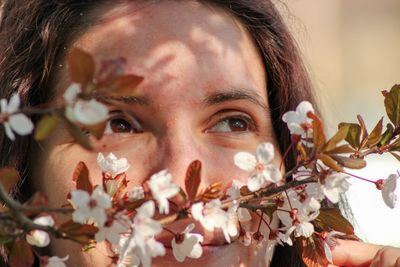 Close-up portrait of woman with pink flowers