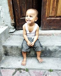 Portrait of smiling boy looking away at entrance