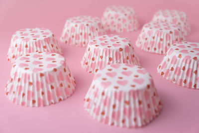 Close-up of cupcakes against pink background