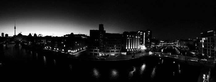 View of illuminated bridge over river at night